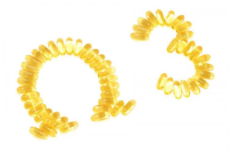 Omega-3 softgels arranged as Greek letter omega and number 3